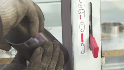 Hands grinder grinds a pipe end on sandpaper machine. Stock Footage 151928727