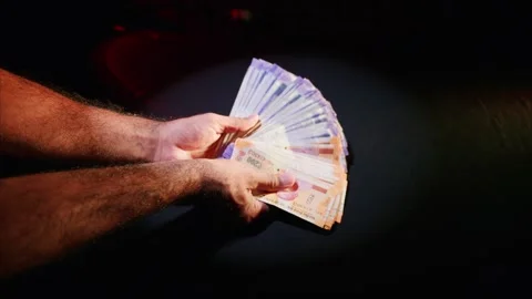 Hands grip spread of colorful rupee notes Stock-Footage 313671237