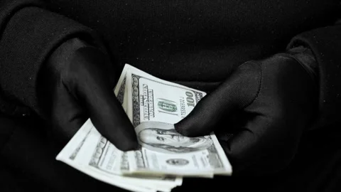 Hands gripping dollar notes. Close-up of US paper money held firmly. Stock Footage 323461730
