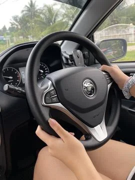 Hands Gripping Steering Wheel While Driving Stock Photos