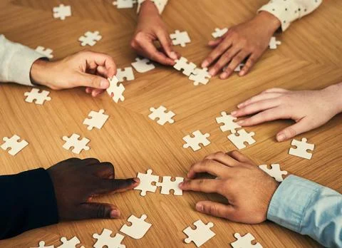Hands, group and puzzle for problem solving in office with synergy Stock Photos