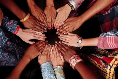Hands of a group of multinational people which stay together in circle. Stock Photos