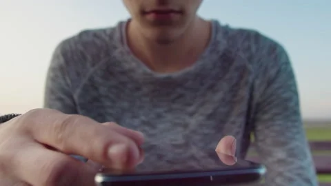 Hands of a guy with a mobile phone, looks through text messages in the mobile Stock Footage 166978157