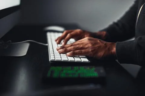 Hands, hacker and typing on computer for coding, data breach or cyber attack at Foto stock