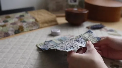 Hands hand sewing a decorative textile patchwork Video stock 315084854