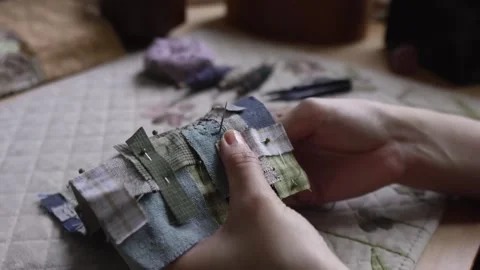 Hands hand sewing a decorative textile patchwork Video stock 315084859