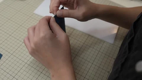 Hands hand stitch leather pouch edge with needle and thread Stock Footage 339642829