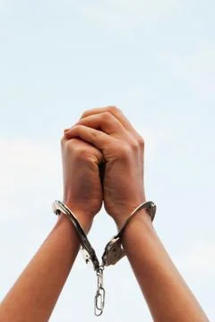 Hands handcuffed Stock Photos