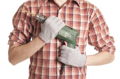 Hands handling an electric drilling machine Stock Photos