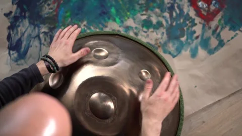 Hands with hang drum close up, man practicing meditation music Stock Footage 253080958