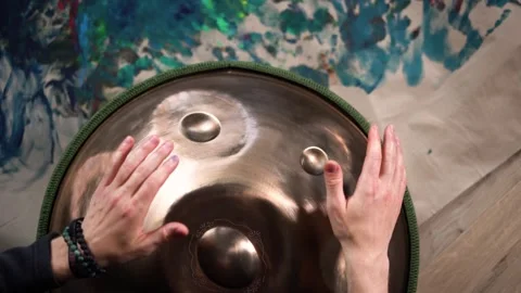 Hands with hang drum close up, man practicing meditation music Stock Footage 253081017
