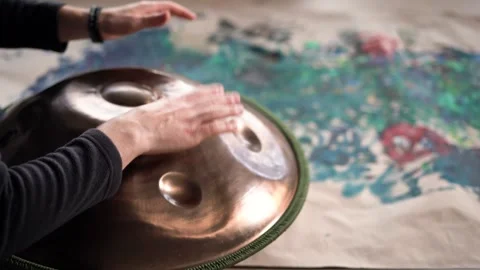 Hands with hang drum close up, man practicing meditation music Stock Footage 253081089
