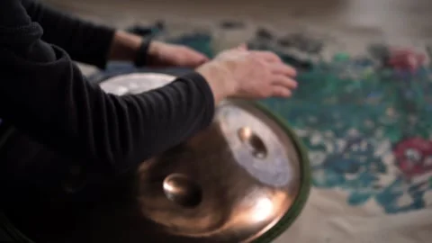 Hands with hang drum close up, man practicing meditation music Stock Footage 253787907