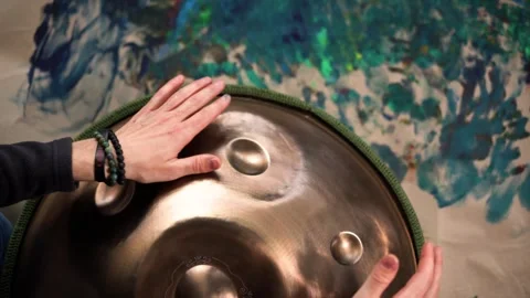 Hands with hang drum close up, man practicing meditation music Stock Footage 253788128