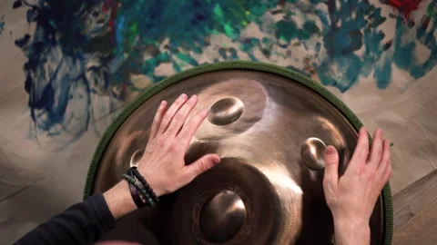 Hands with hang drum close up, man practicing meditation music Stock Footage 255574058