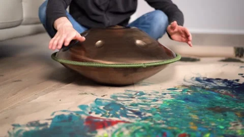 Hands with hang drum close up, man practicing meditation music Stock Footage 255786367