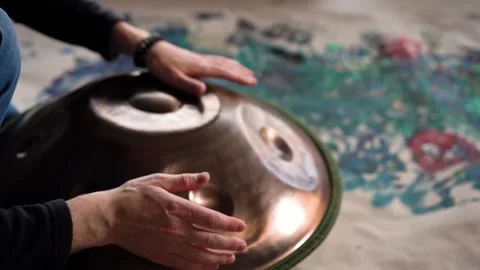 Hands with hang drum close up, man practicing meditation music Stock Footage 256093805