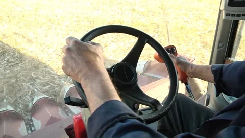 Hands harvester driver on the steering wheel and joystick control Stock Footage 99431669