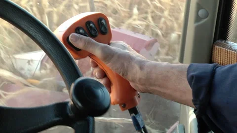 Hands harvester driver on the steering wheel and joystick control Stock-Footage 99431824
