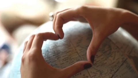 Hands in heart shape on globe Stock Footage 76299476
