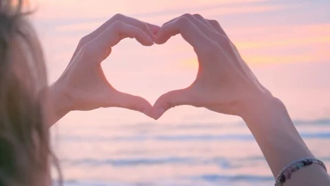 Hands as heart shape with pastel sunset Stock Footage 122765570