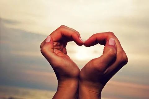 Hands in the heart shape at sunset Foto stock