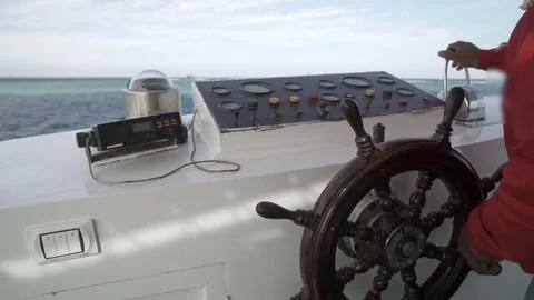 Hands at the helm of the yacht Stock Footage 84067079