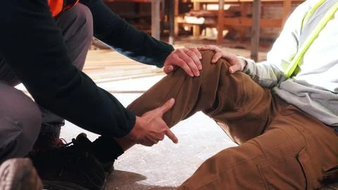 Hands, help and carpenter with leg injury in factory, safety failure or hur.. Stock Photos