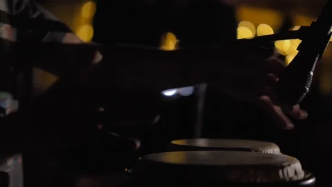 Hands hitting bongo drums percussion instrument in a night club Stock Footage 122456123