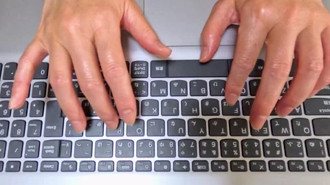 Hands hitting the keyboard seen from above Stock Footage 243805309