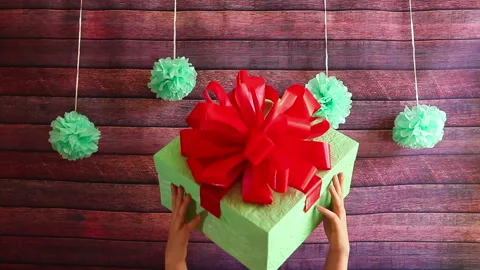 Hands hold beautiful gift box with red ribbon, holidays concept Stock Footage 98235956