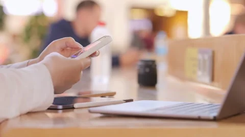 Hands hold a black phone while seated Stock Footage 314325822