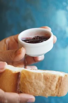 Hands hold bread and jam on a blue background Stock Photos