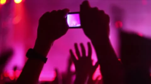 Hands hold camera with digital display among people at rave party Stock Footage 10680416