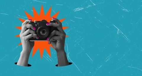 Hands hold a camera in front of a bright background. The scene captures the a Stock Photos