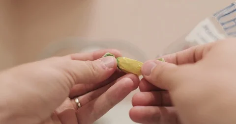 Hands hold a candy lollipop and open a candy wrapper then eat. First person view Stock Footage 110245817