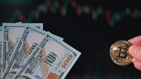 Hands hold cash while displaying cryptocurrency coins, showing the contrast Video stock 338301430