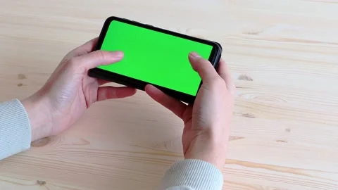 Hands hold a chroma key smartphone and fingers gesture. Video stock 153858176
