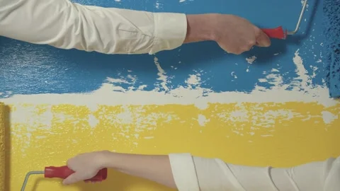Hands hold color brush-roller and paint horizontal Ukraine blue yellow flag Stock Footage 172600170