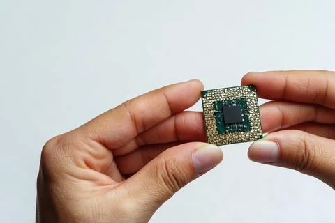 Hands hold electronic chip 스톡 사진