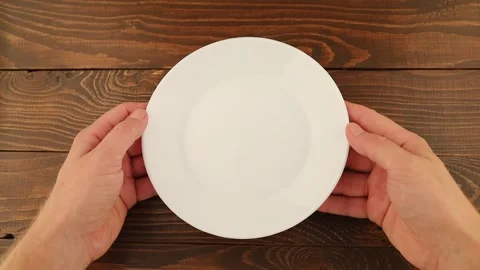 Hands hold an empty white plate Stock Footage 252277646