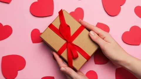 Hands hold gift box present with red bow for valentine's day Stock Footage 145717873