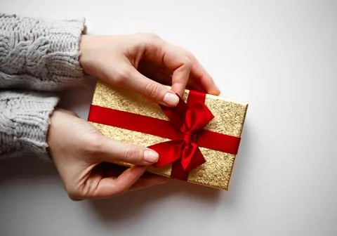 Hands hold a gift on a white background Stock Photos