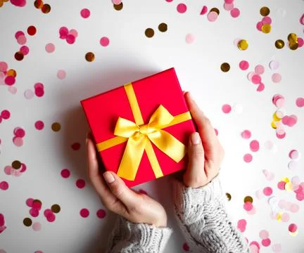 Hands hold a gift on a white background Stock Photos