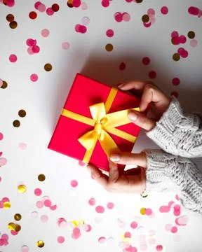 Hands hold a gift on a white background Stock Photos