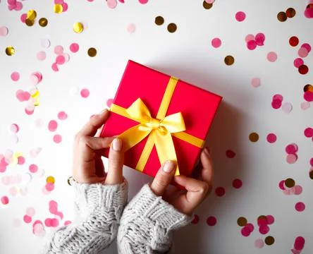 Hands hold a gift on a white background Stock Photos
