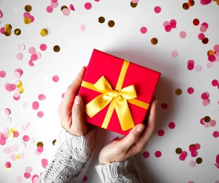 Hands hold a gift on a white background Stock Photos