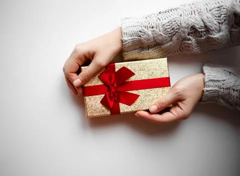 Hands hold a gift on a white background Stock Photos