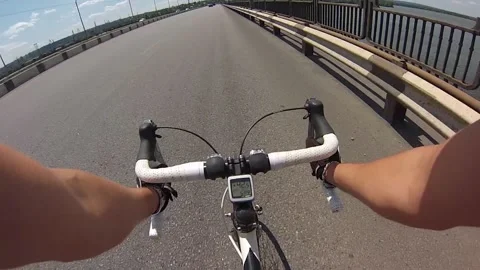 Hands hold the handlebars of a bicycle while riding Stock Footage 205082553