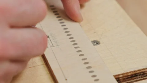 Hands hold Illyushin plane model detail and mark with pencil Stock Footage 127377154